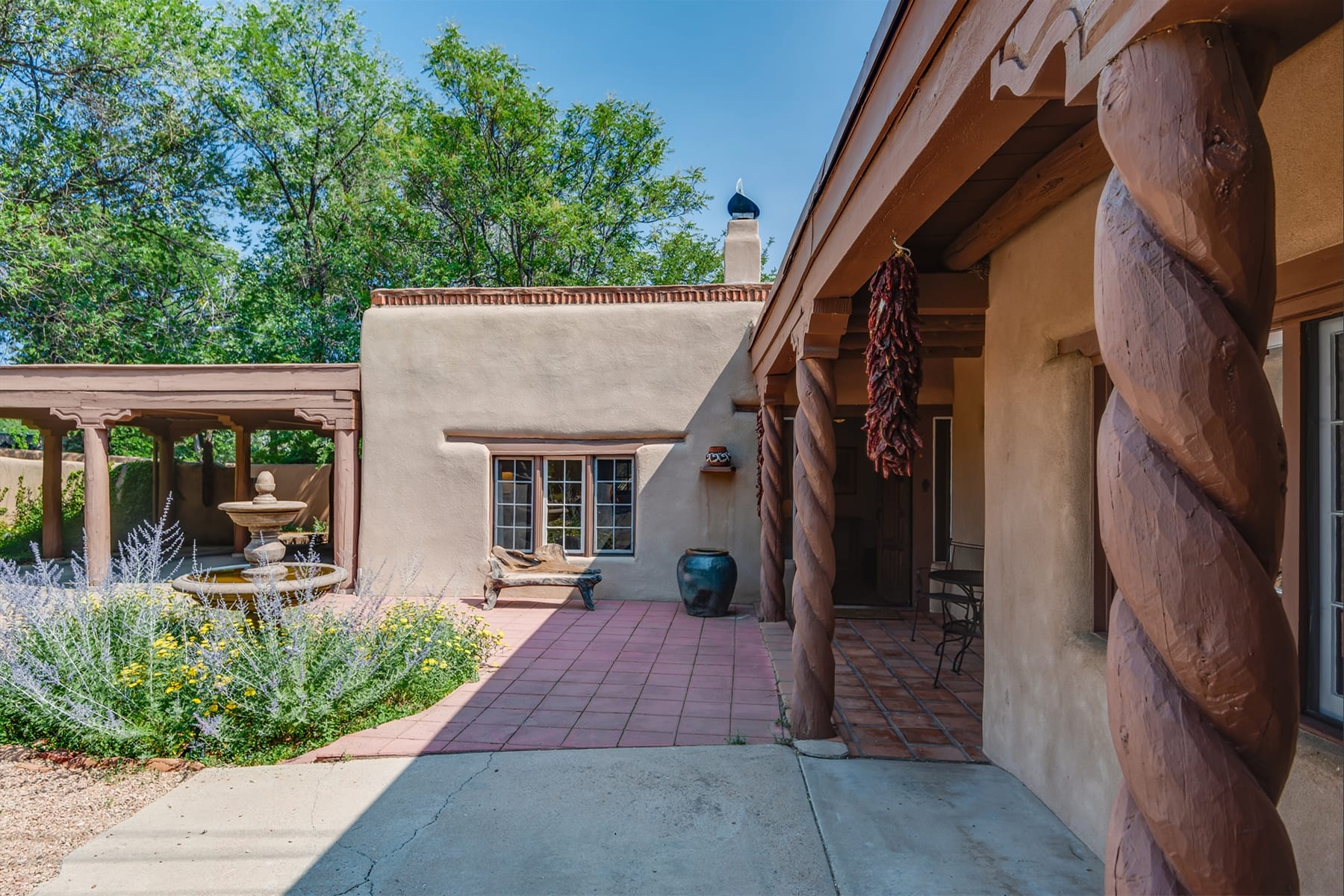 Adobe house with courtyard fountain.