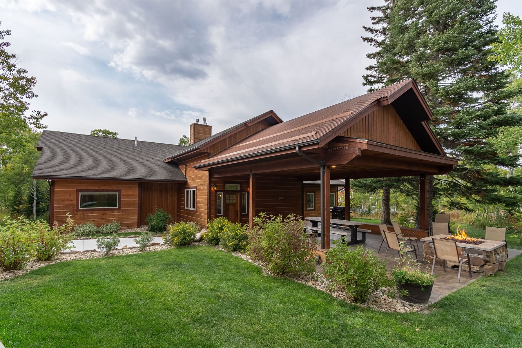 Wooden house with covered patio.