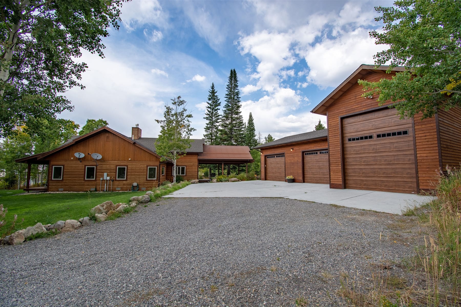 Wooden house and garage in forest