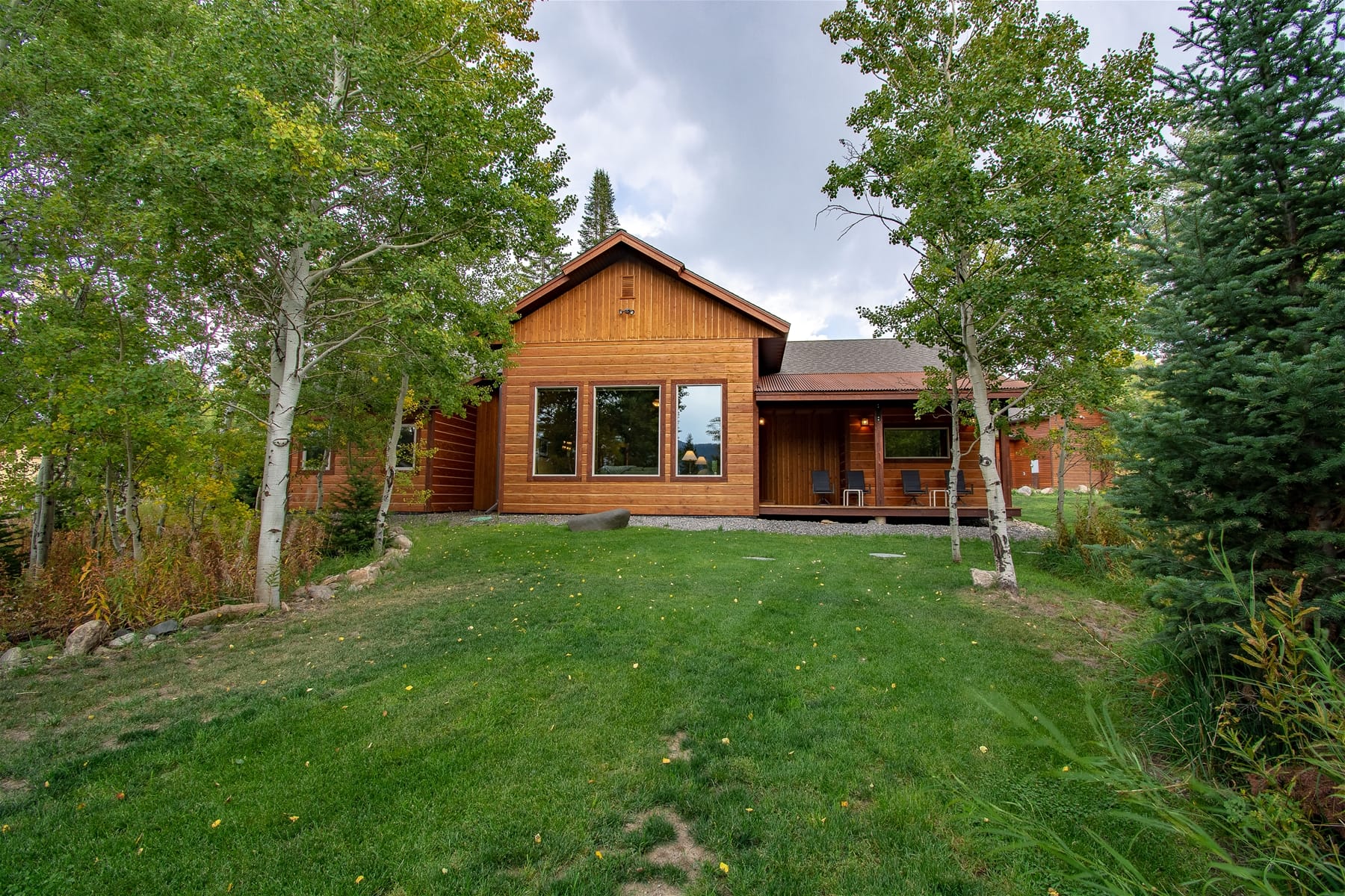 Wooden house in a green yard.