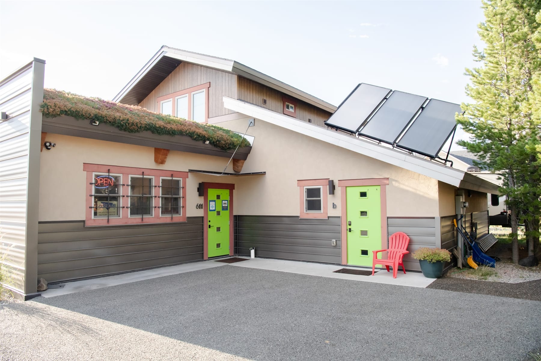 Two-story building with green doors.