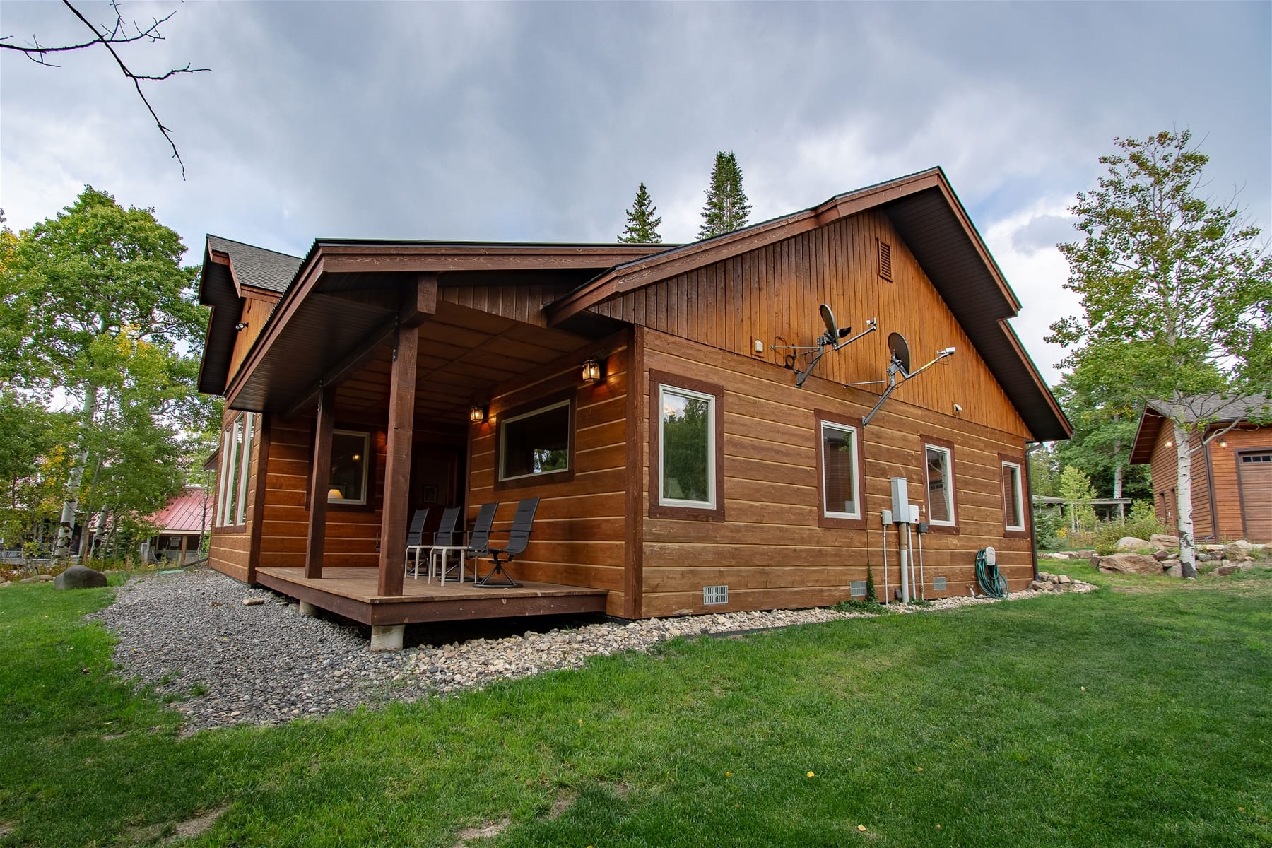 Wooden house with porch, lawn.