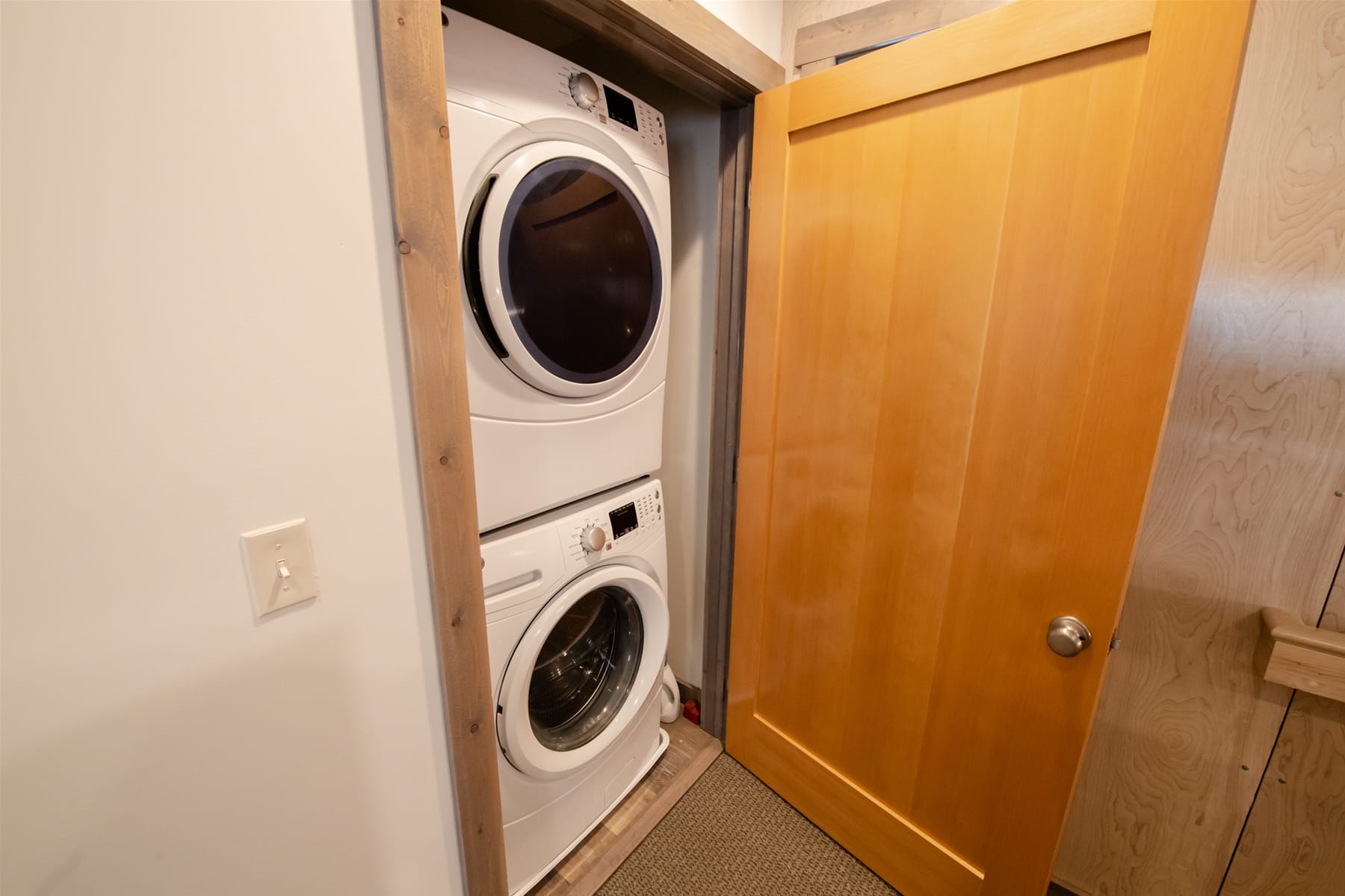 Stacked washer and dryer closet.