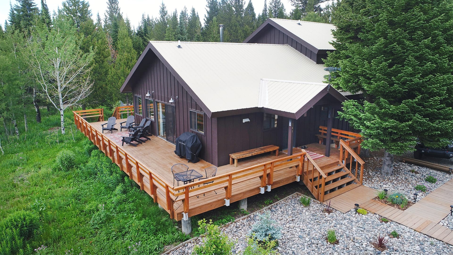 Cabin with deck in forest.