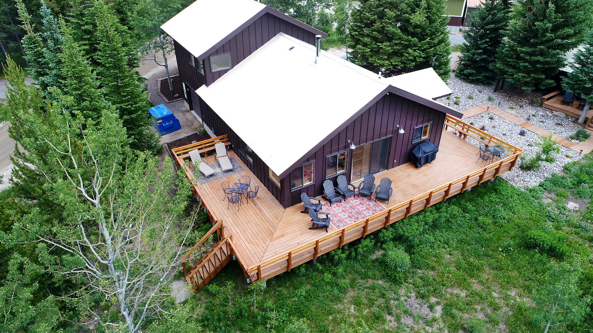 Wooden cabin with large wraparound deck.