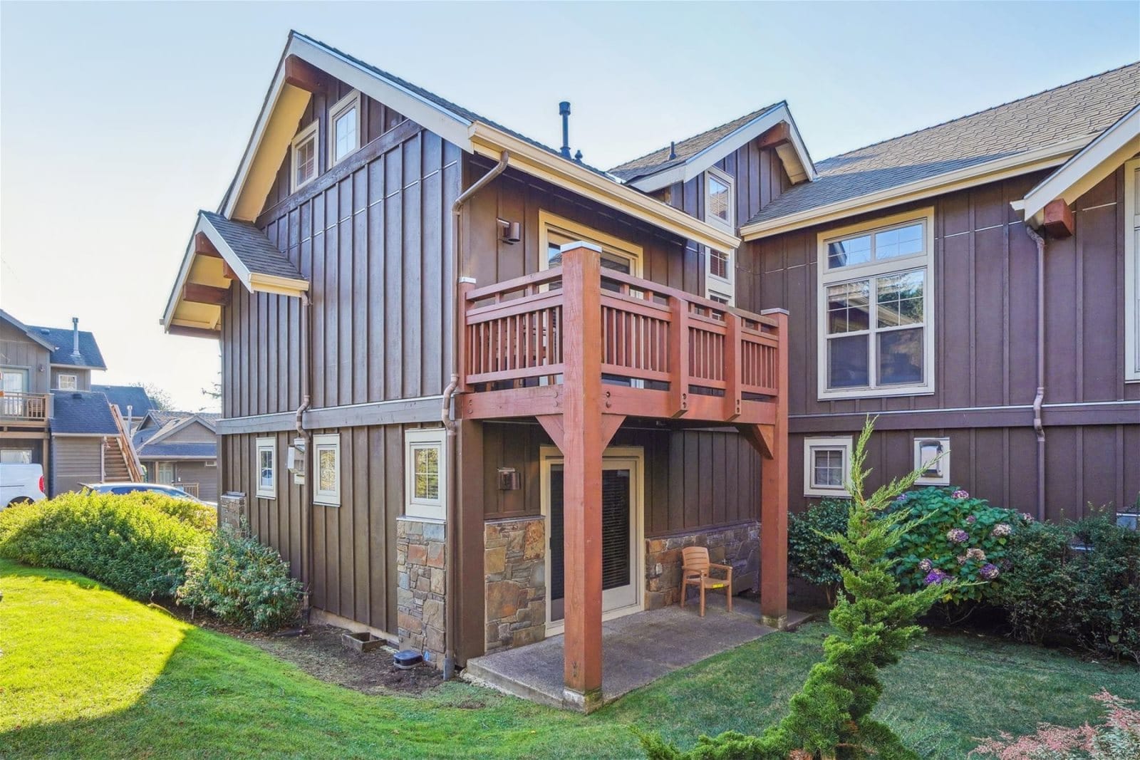 Brown house with balcony and garden