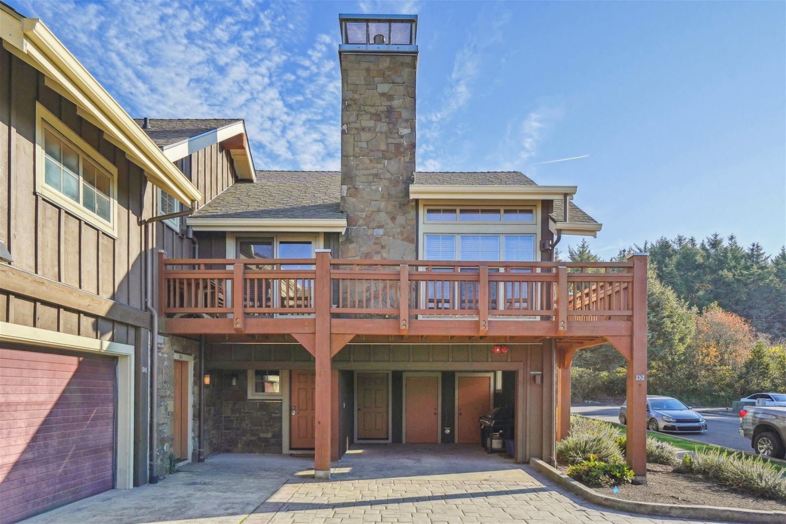 Two-story house with wooden balcony.