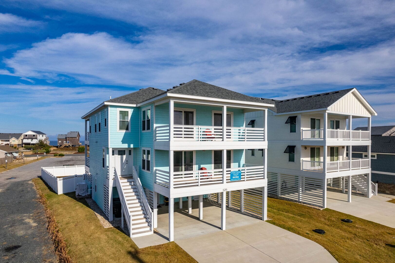 Two-story pastel blue house.