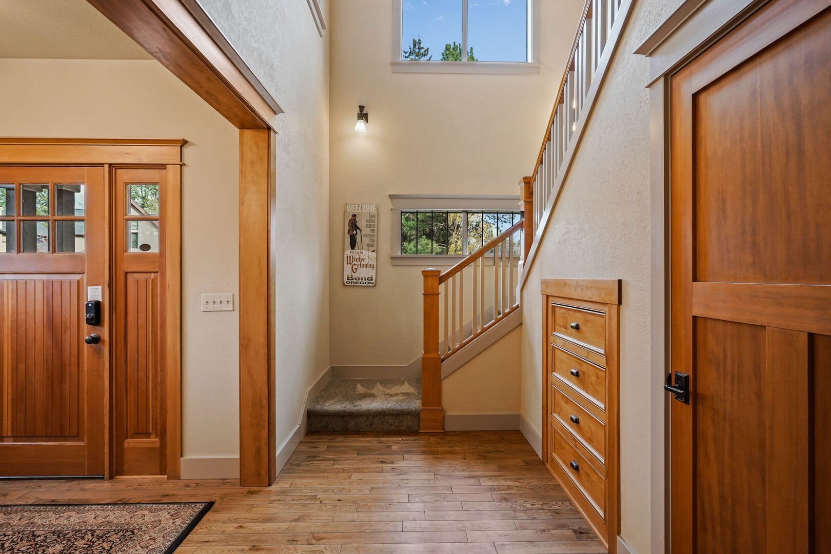 Cozy entryway with wooden staircase.