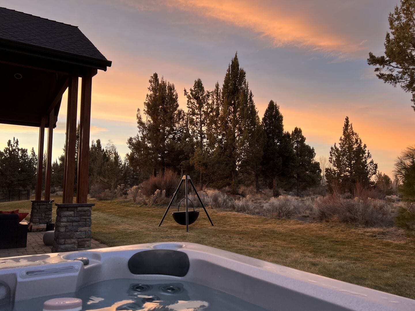 Outdoor hot tub at sunset.