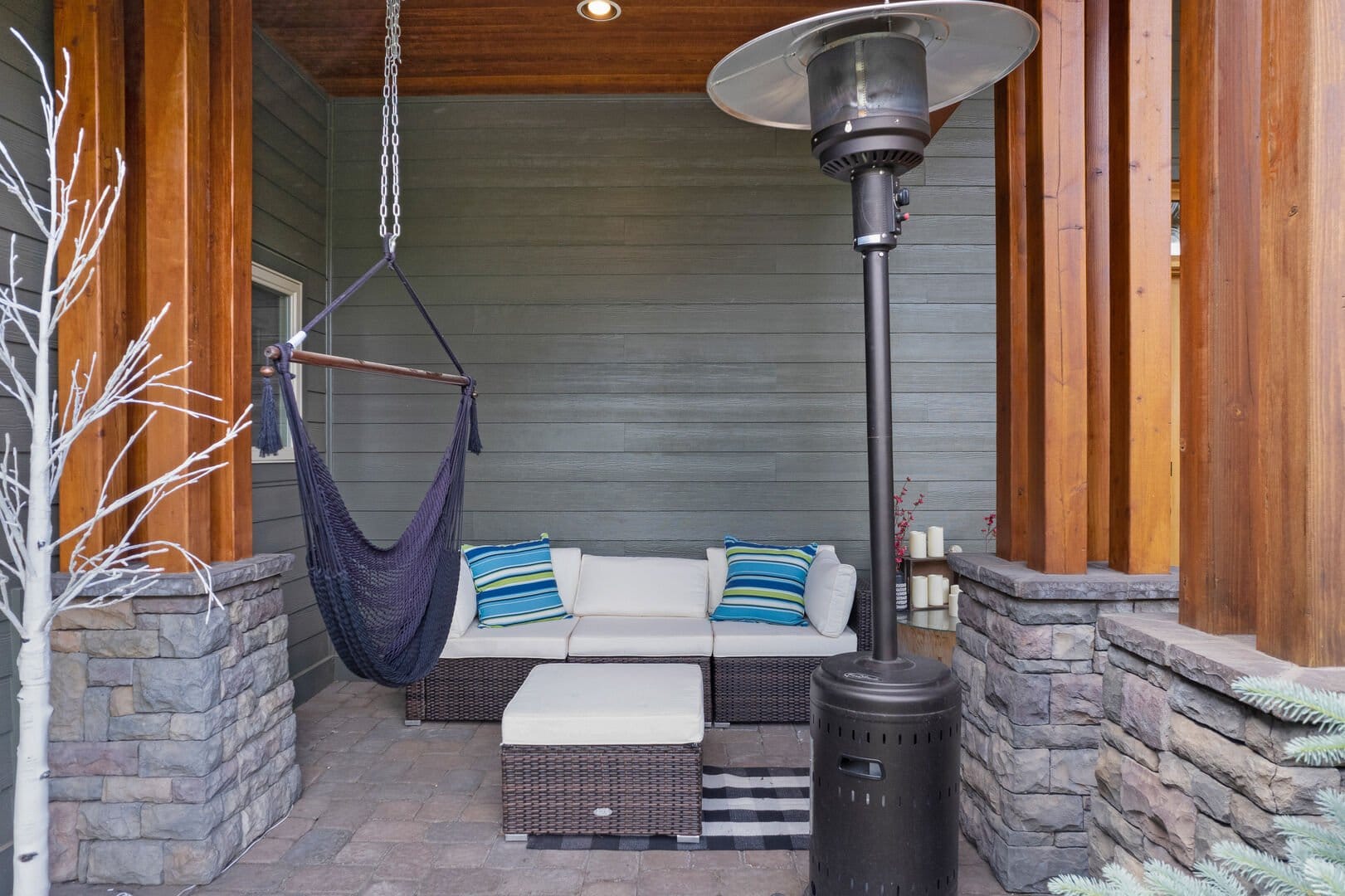 Modern patio with couch and heater.