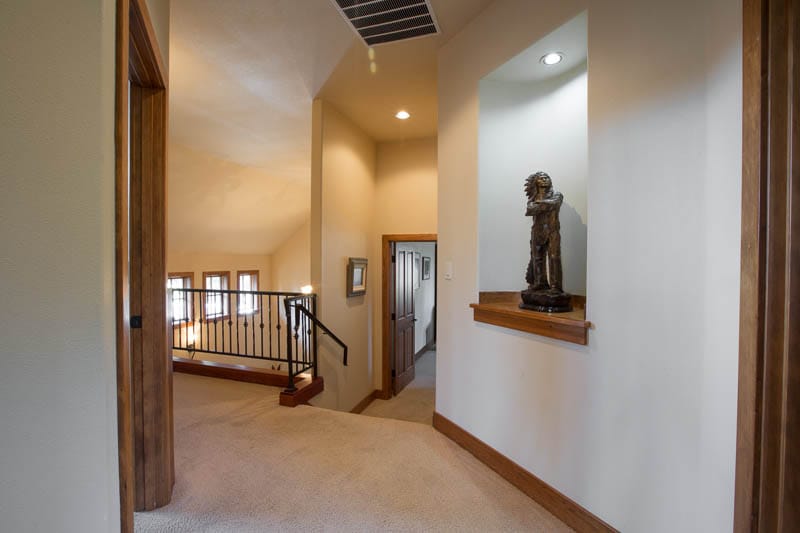 Upstairs hallway with decorative statue.