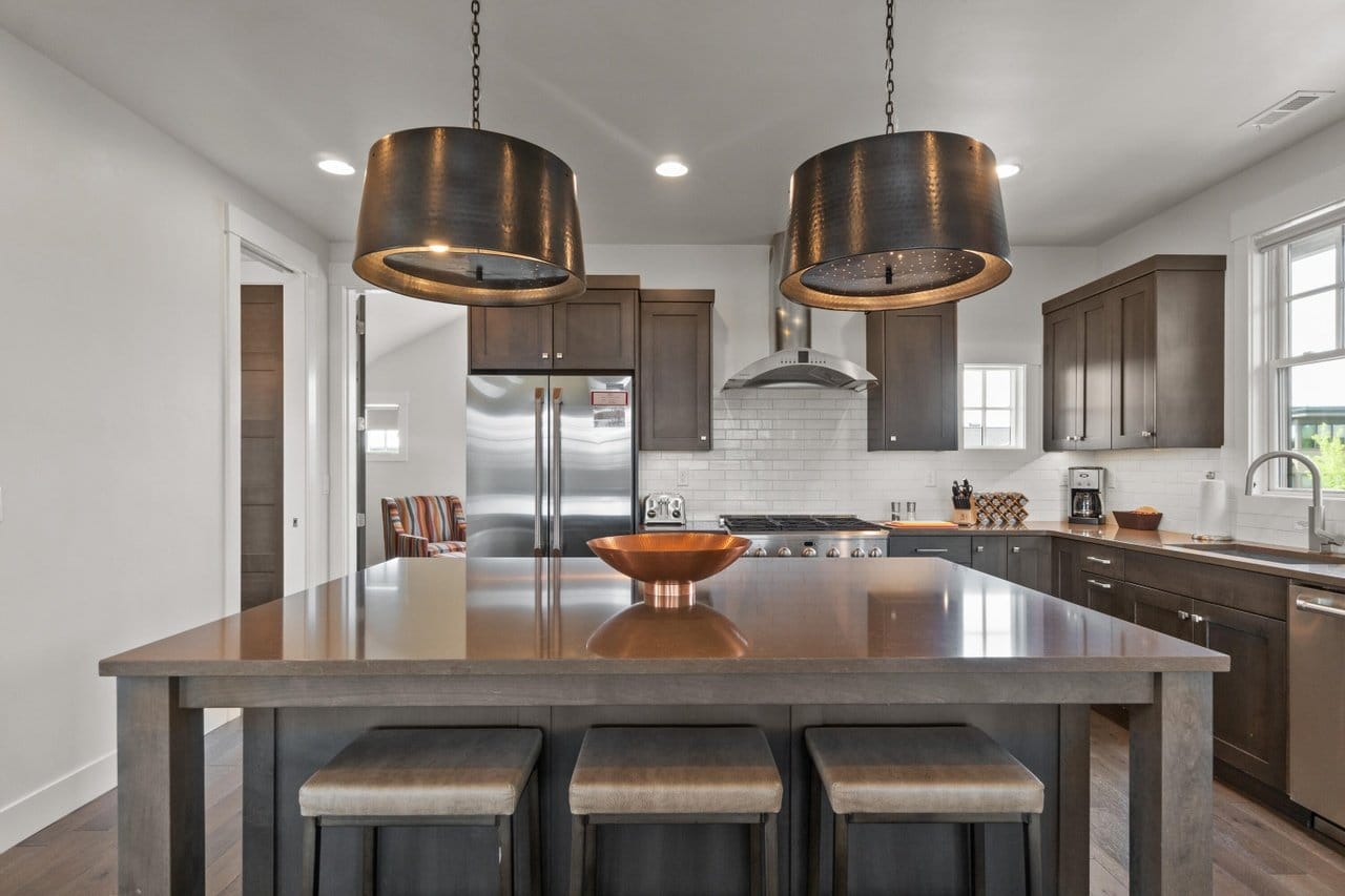 Modern kitchen with island and stools.