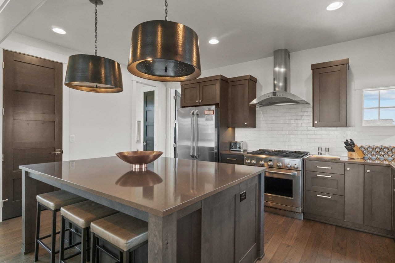 Modern kitchen with island and lighting.