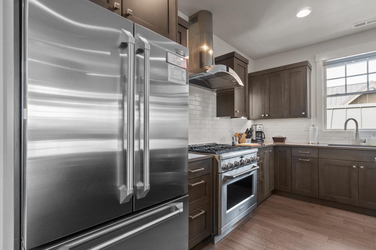 Modern kitchen with stainless steel appliances.