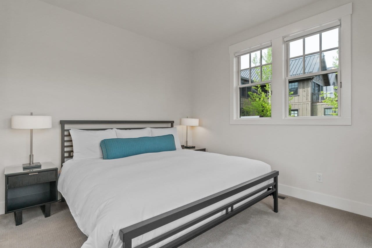 Minimalist bedroom with large window.