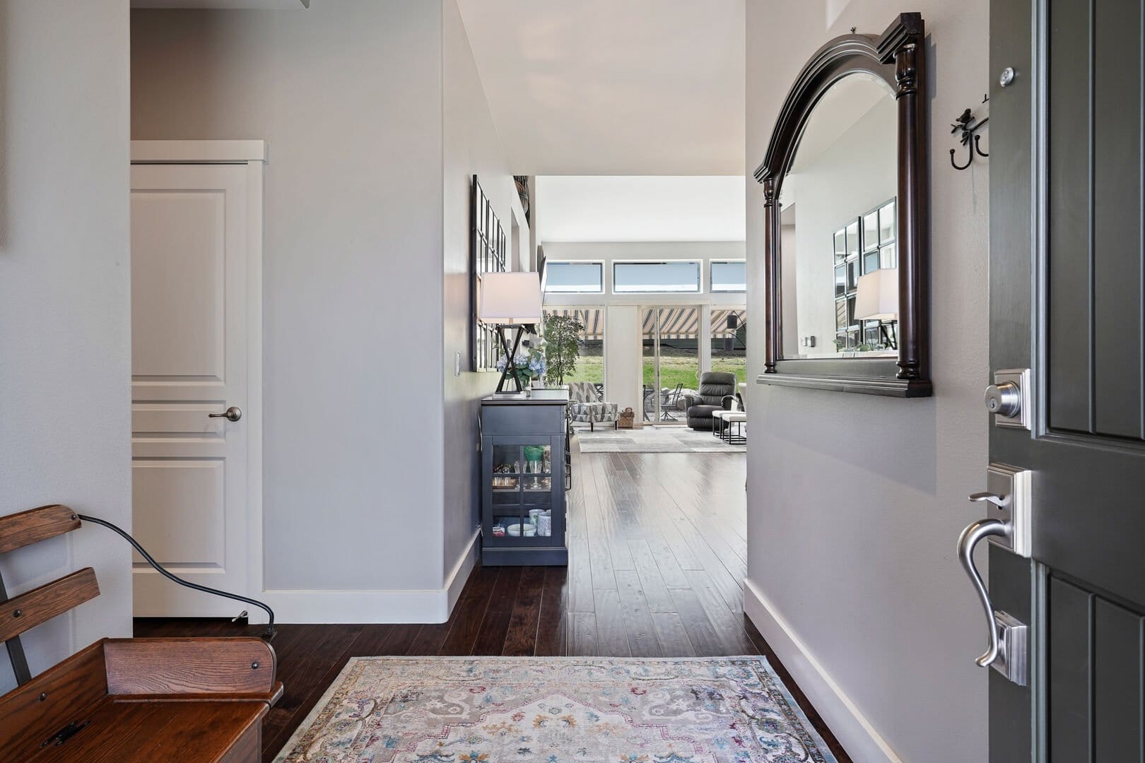 Home entrance with hallway mirror.