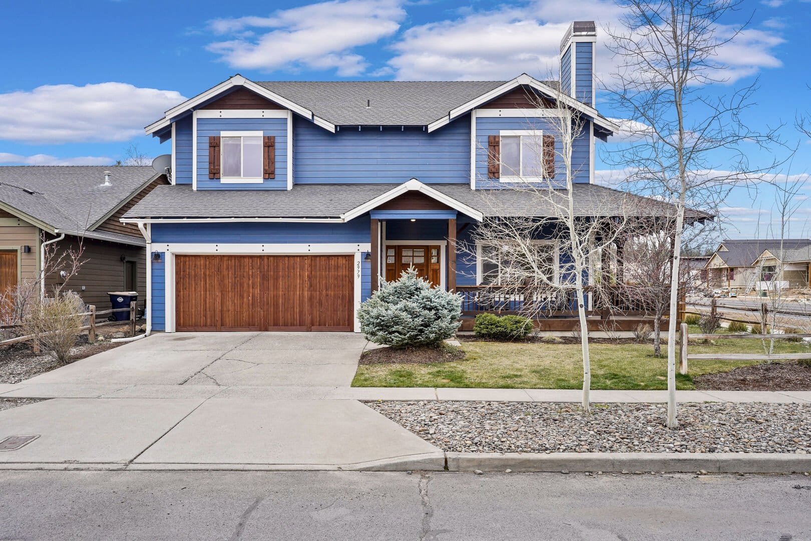 Blue two-story house with garage.