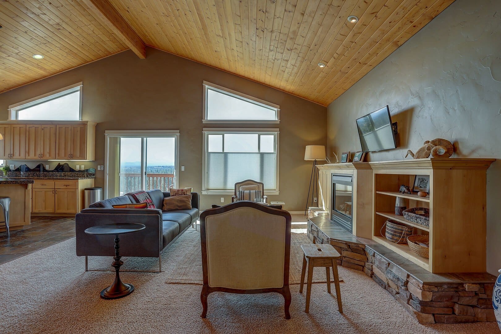 Rustic living room with wood ceiling.