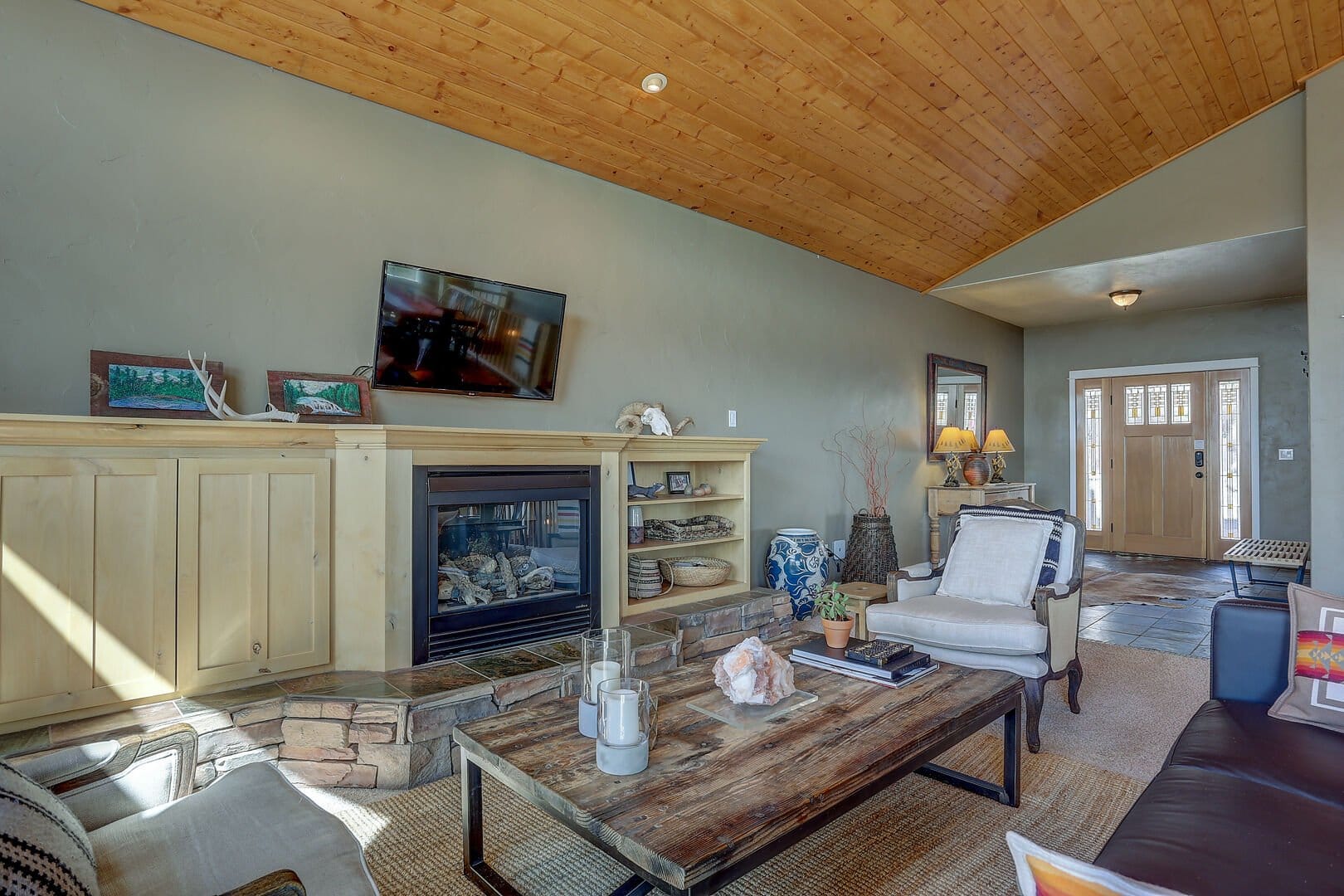 Cozy living room with wooden ceiling.