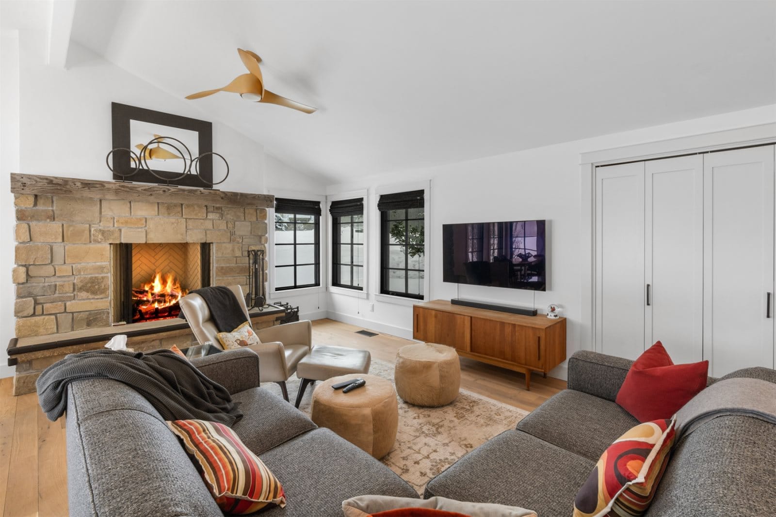 Modern living room with stone fireplace.