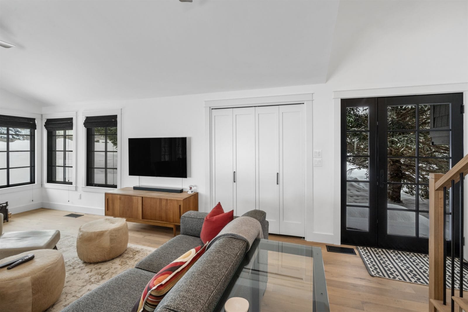 Modern living room with black windows.