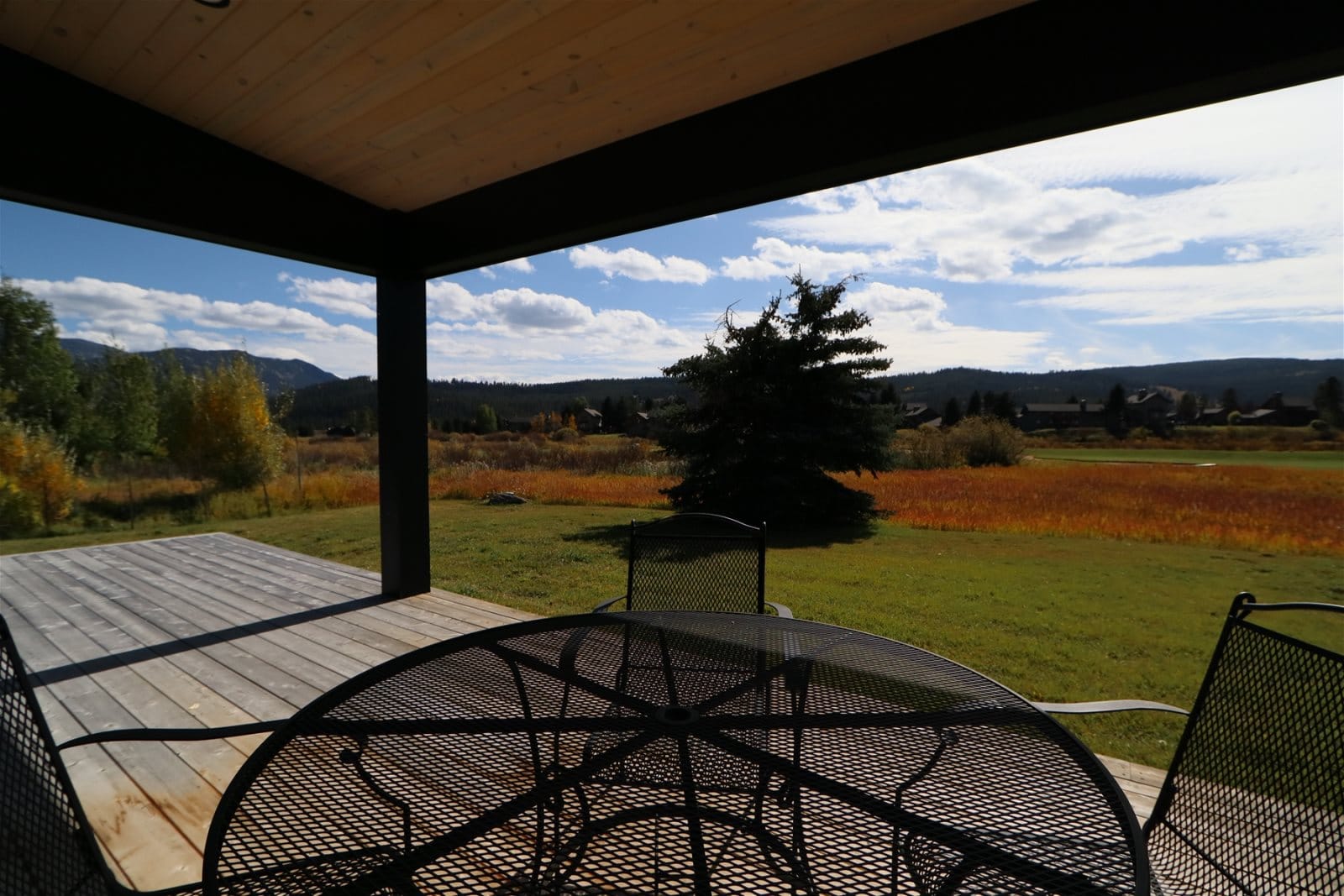 Patio with table overlooking meadow.