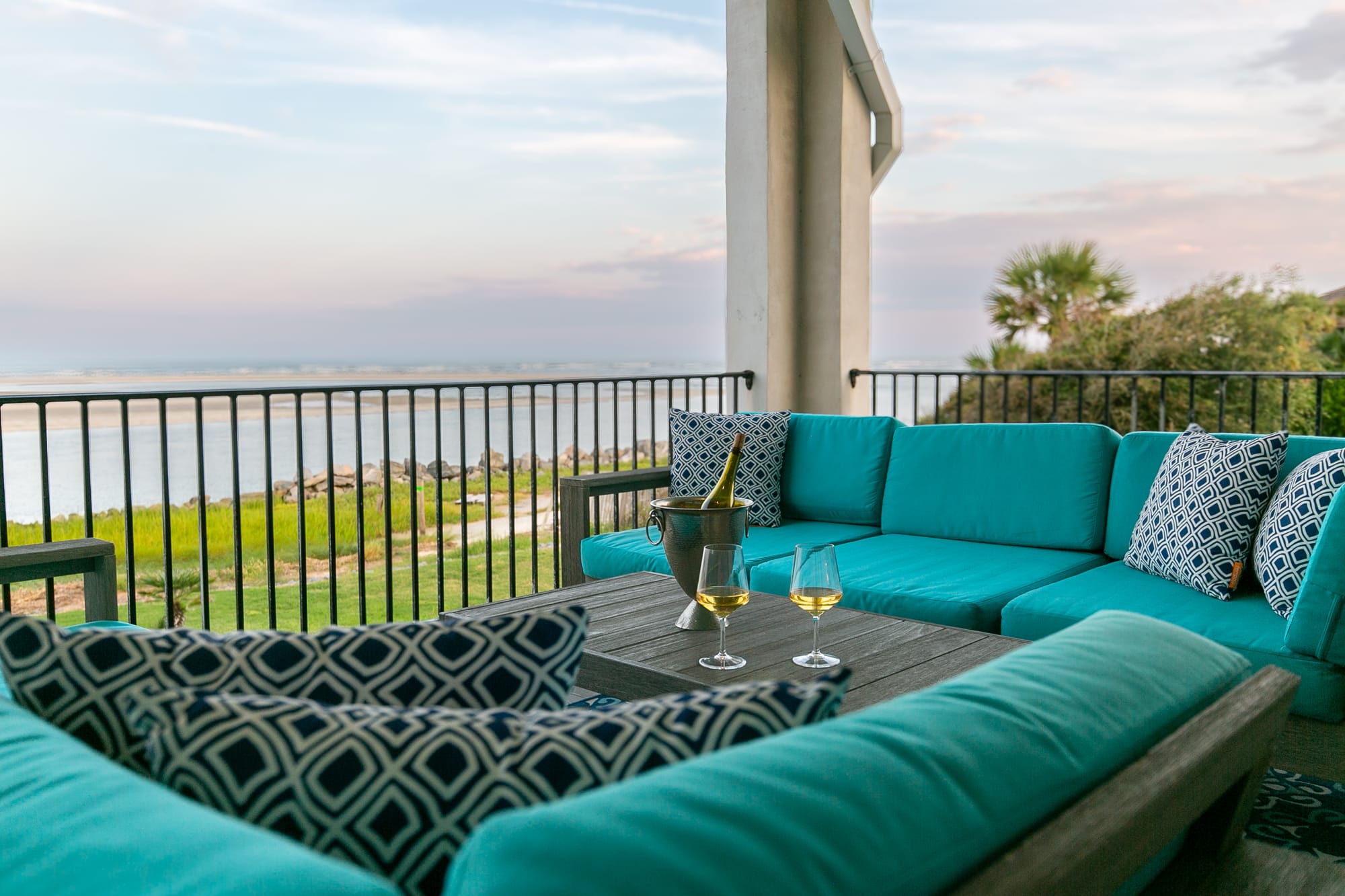 Beachfront patio with turquoise furniture.