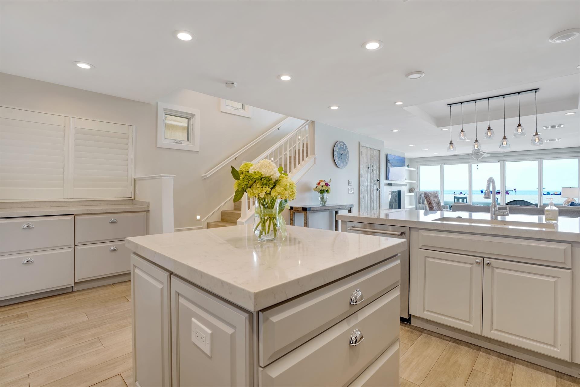 Modern kitchen with island and flowers.