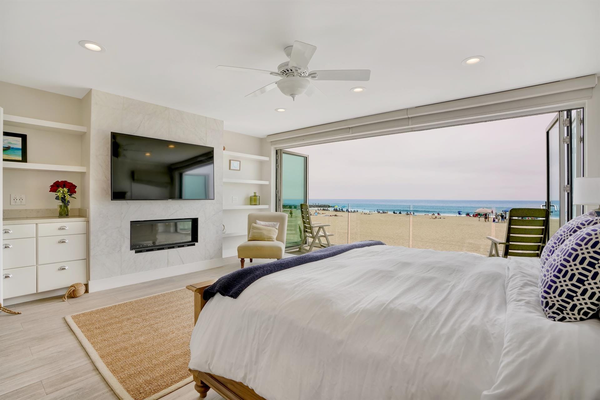 Beachfront bedroom with large windows.