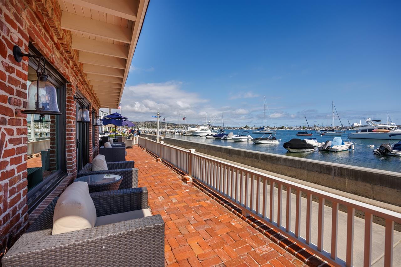 Waterfront patio, boats in marina.