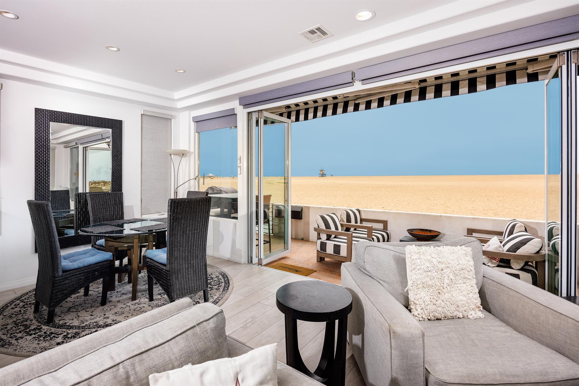 Beachfront living room with large window.