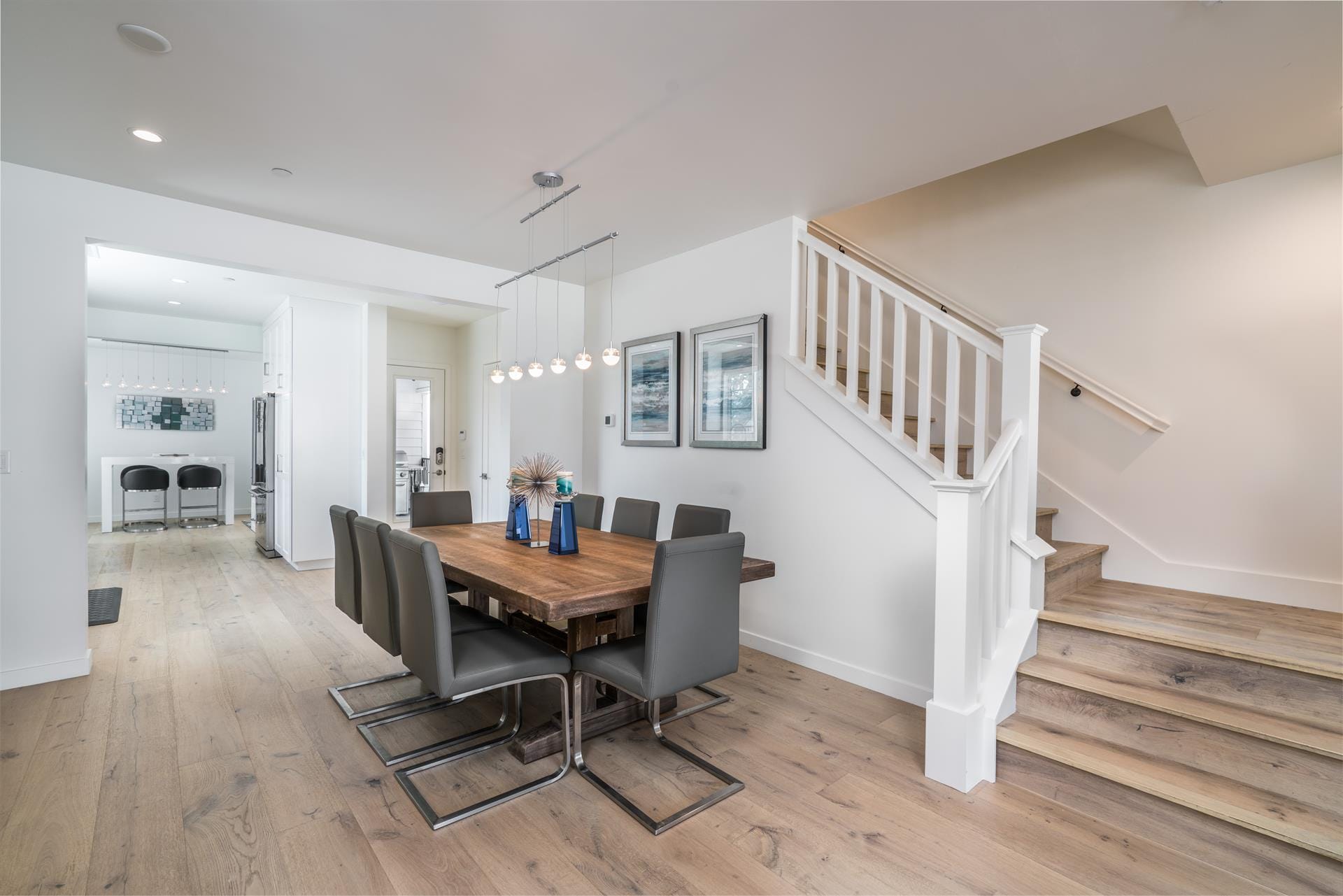 Modern dining room with staircase.