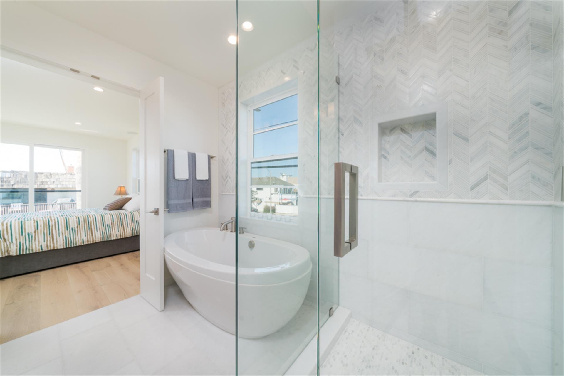 Modern bathroom with adjacent bedroom.