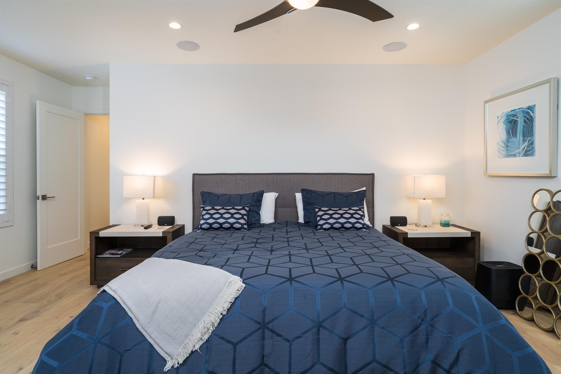 Modern bedroom with blue bedding.