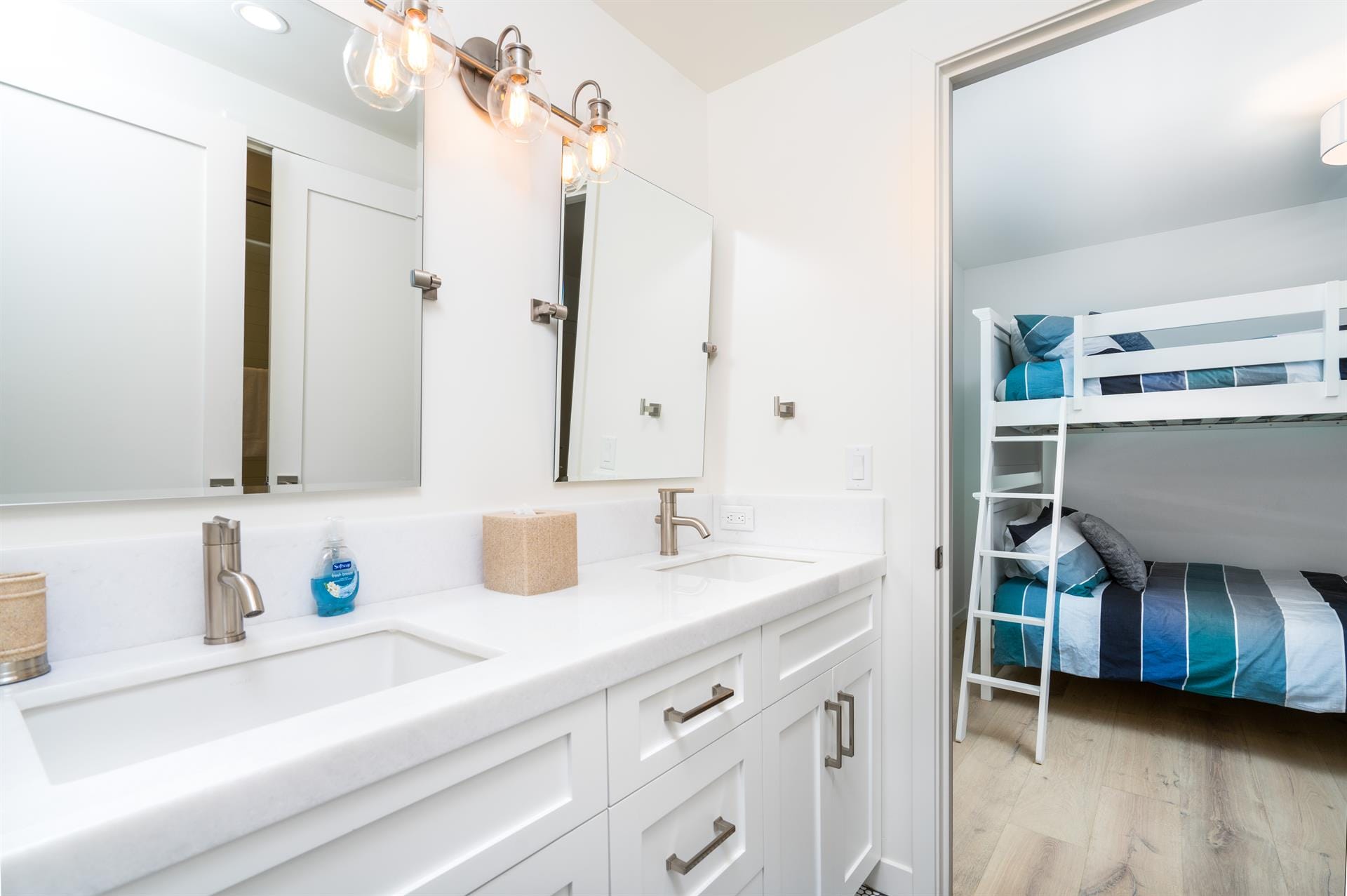 Bathroom with adjacent bunk beds room.