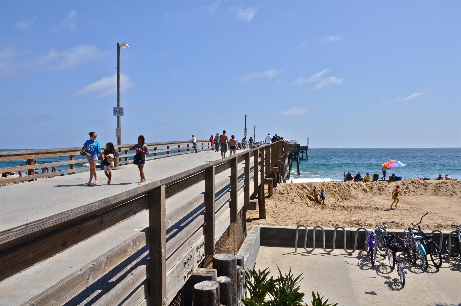 People walking on a beach pier.