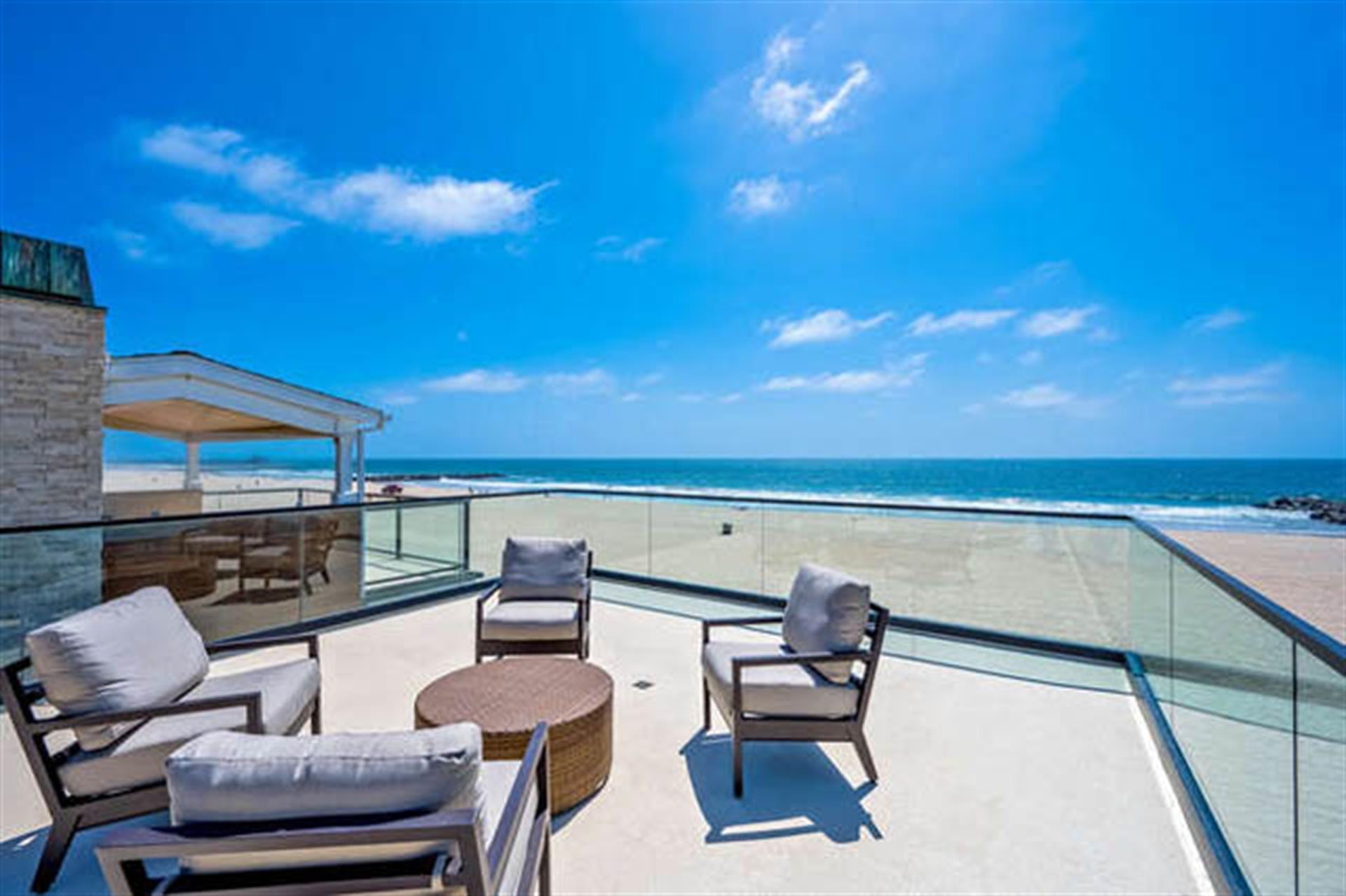 Beachfront patio with ocean view.