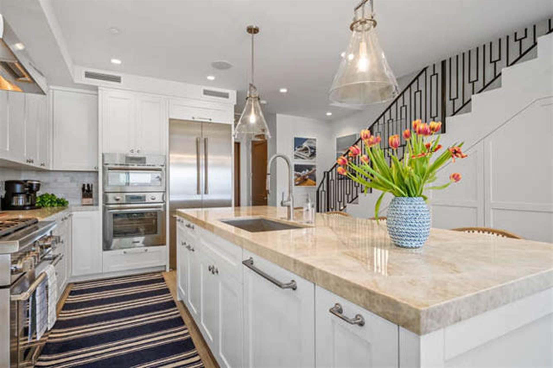 Modern kitchen with island and flowers.