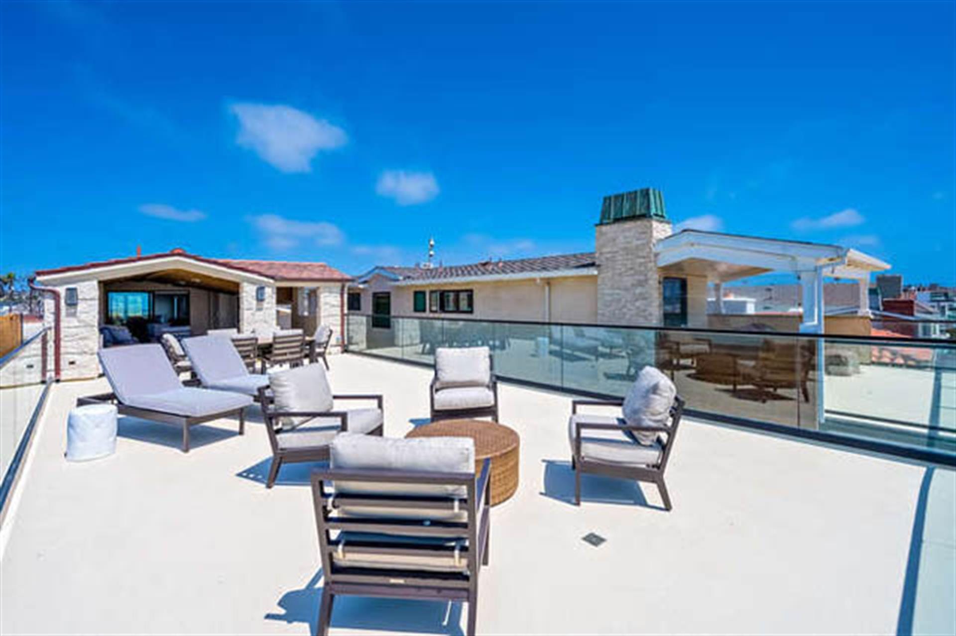 Rooftop patio with lounge chairs.