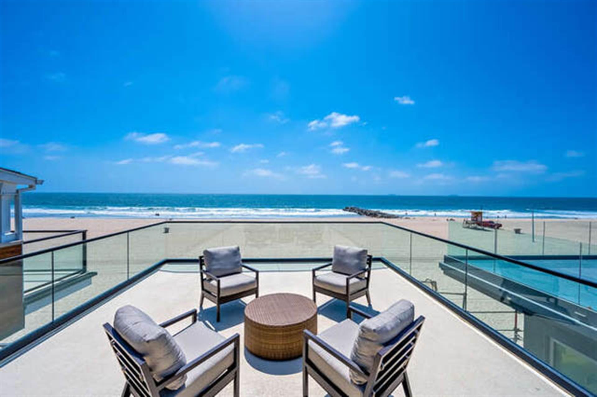 Beachfront patio with ocean view.