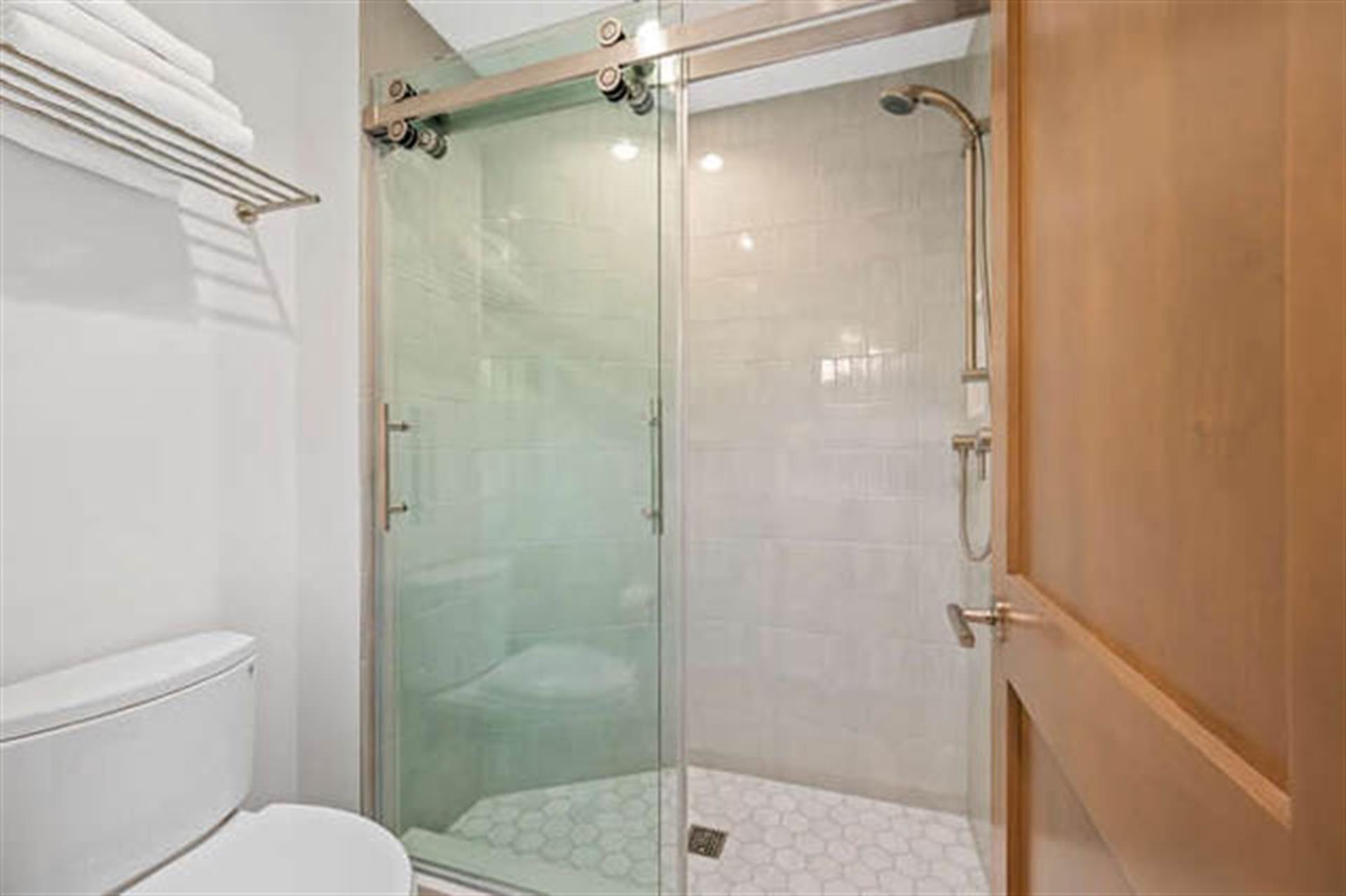 Glass shower with sliding doors.