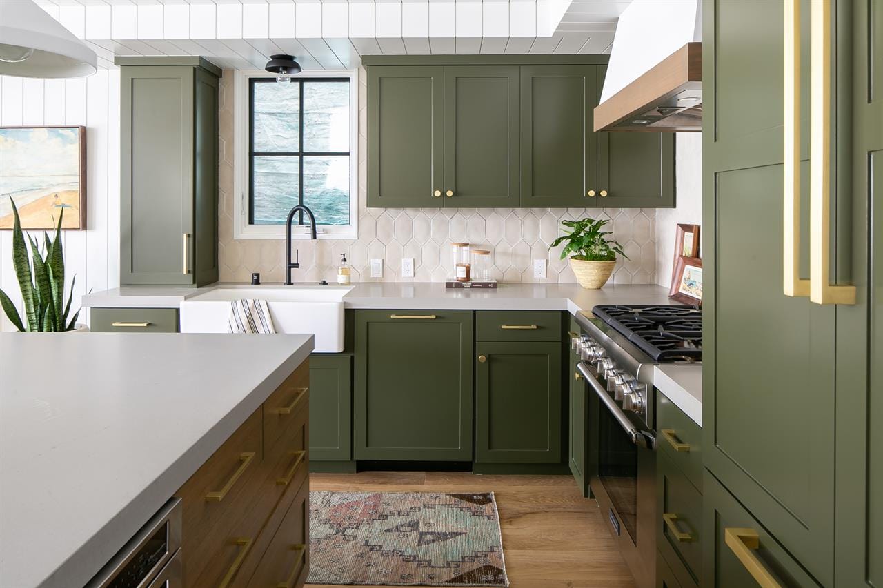 Modern kitchen with green cabinets.