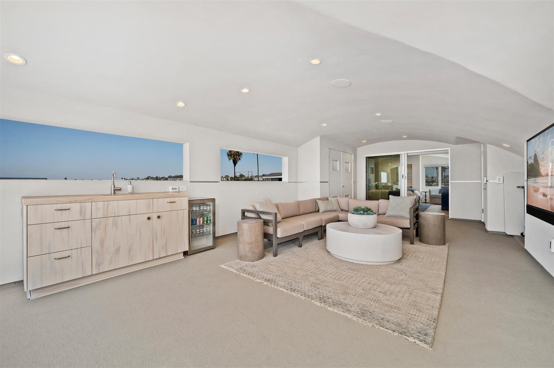 Modern living room with kitchenette.