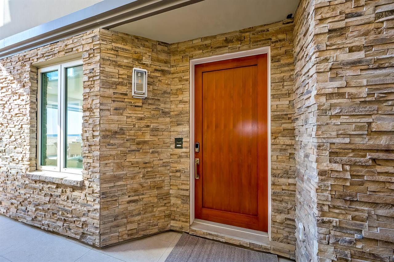 Wooden door surrounded by stone wall.