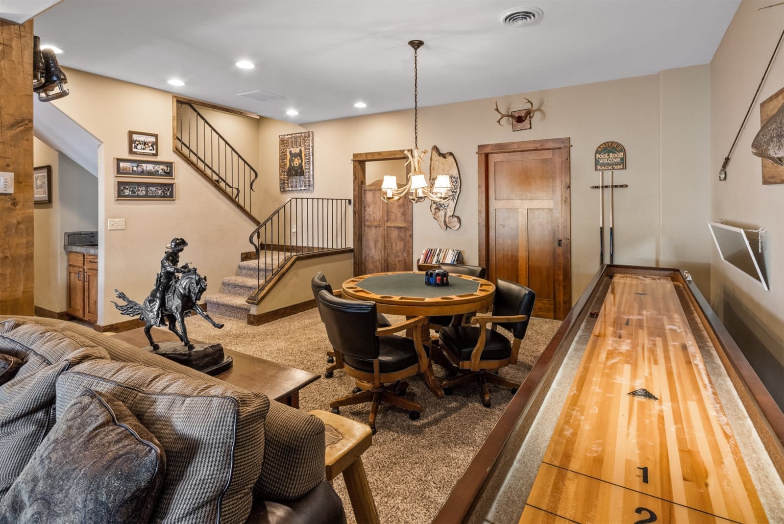 Basement with poker and shuffleboard.