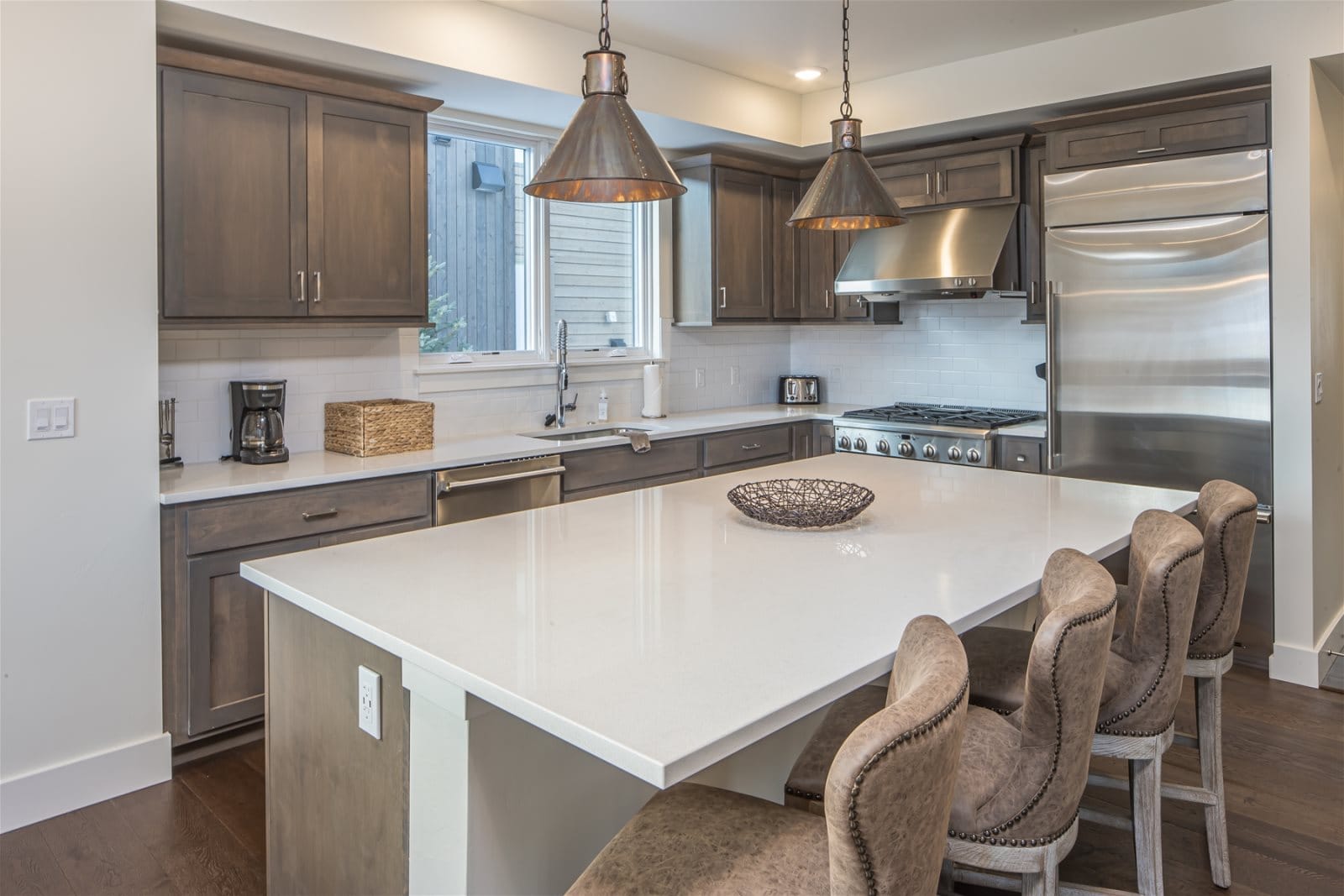 Modern kitchen with island and stools.