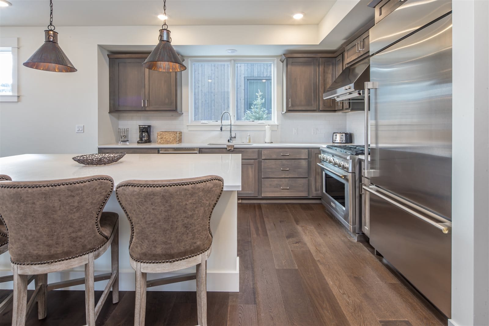 Modern kitchen with island and stools.