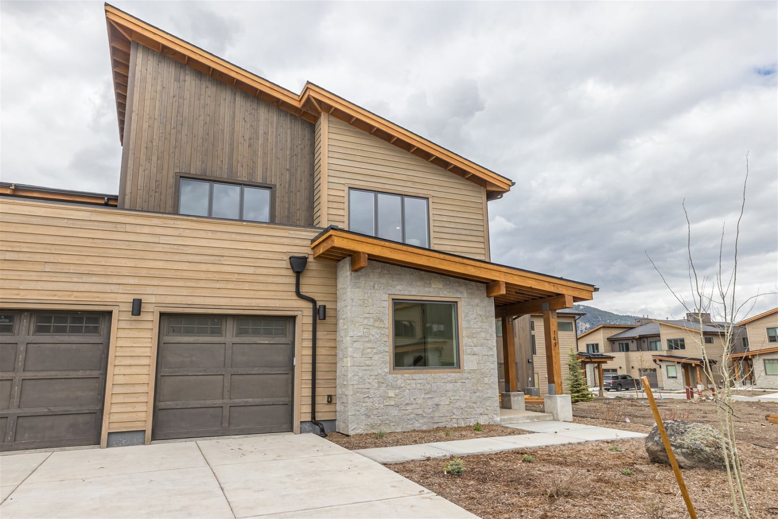 Modern wooden two-story house exterior.