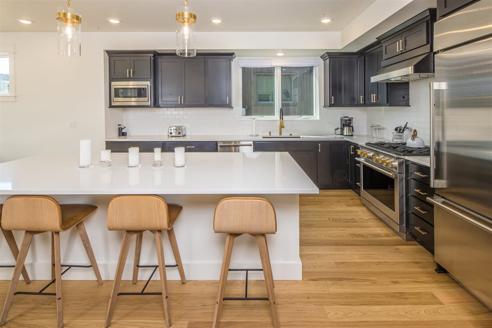 Modern kitchen with island and stools.